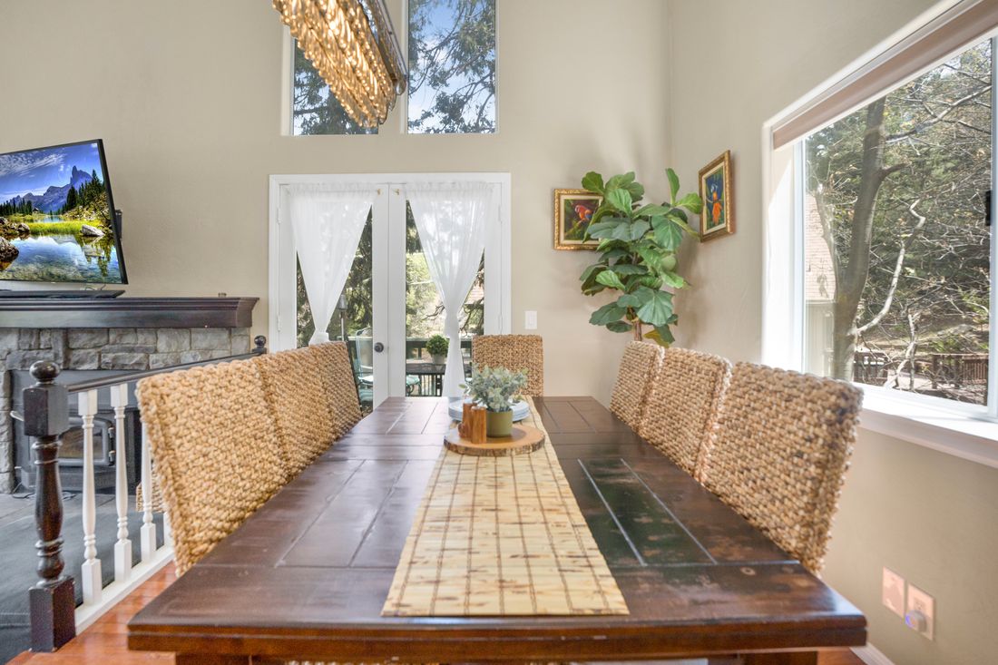 Long dining table beside a wall of windows.